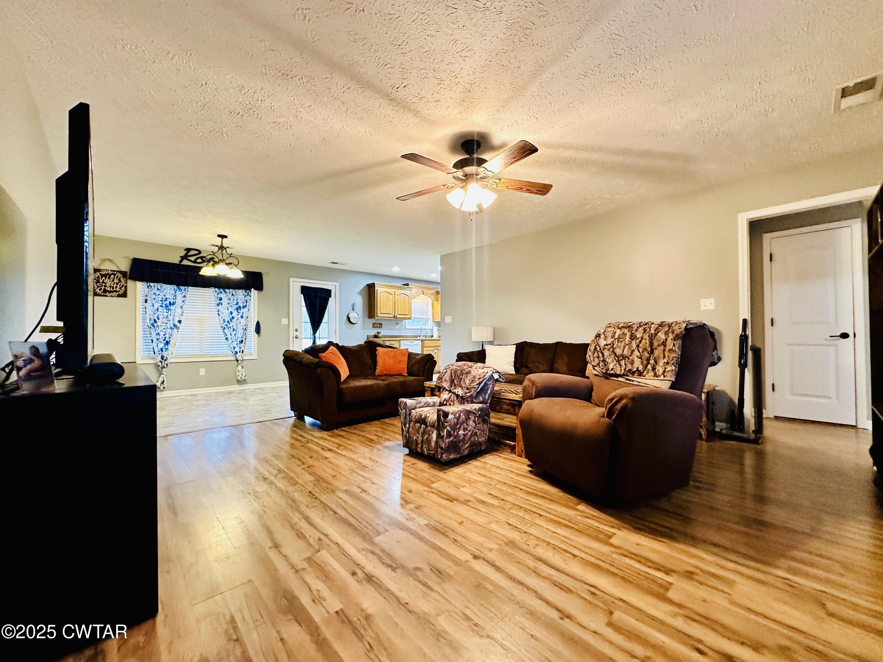 75 Bray Lane Beech Bluff, TN 38313 - Photo 5 of 25 a living room with furniture a flat screen tv and a ceiling fan