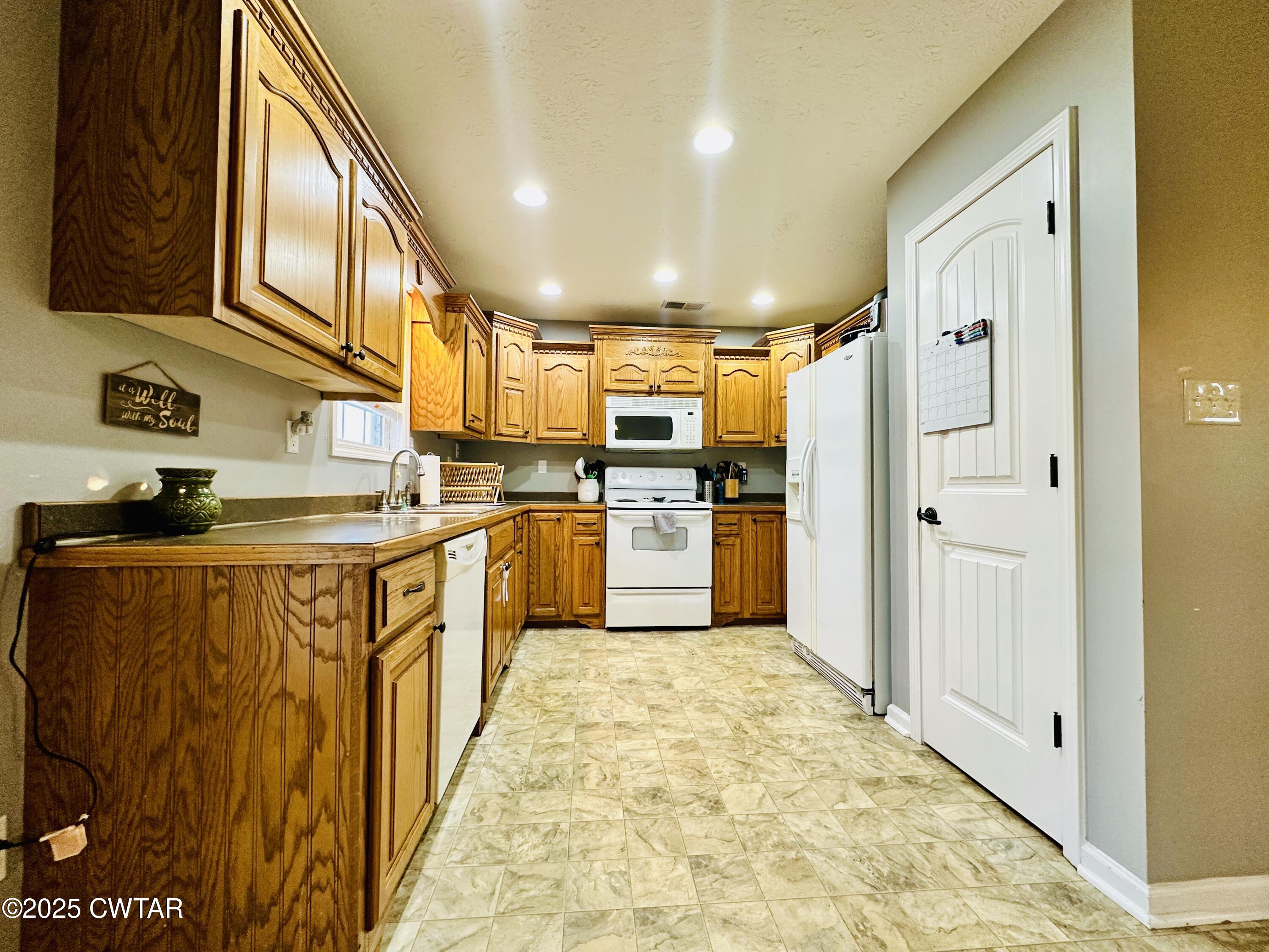 75 Bray Lane Beech Bluff, TN 38313 - Photo 10 of 25 a kitchen with stainless steel appliances granite countertop a refrigerator and a stove top oven