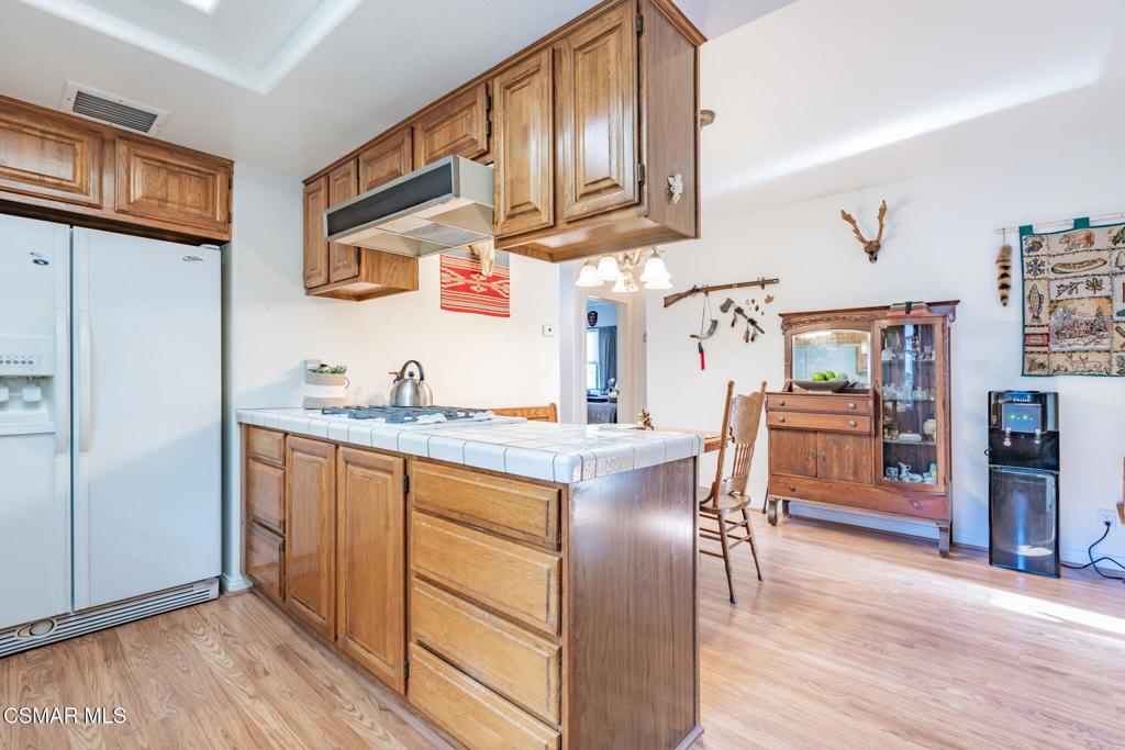 6078 Peppertree Lane Simi Valley, CA 93063 - Photo 18 of 59 a open kitchen with stainless steel appliances granite countertop a refrigerator a stove and a wooden floors