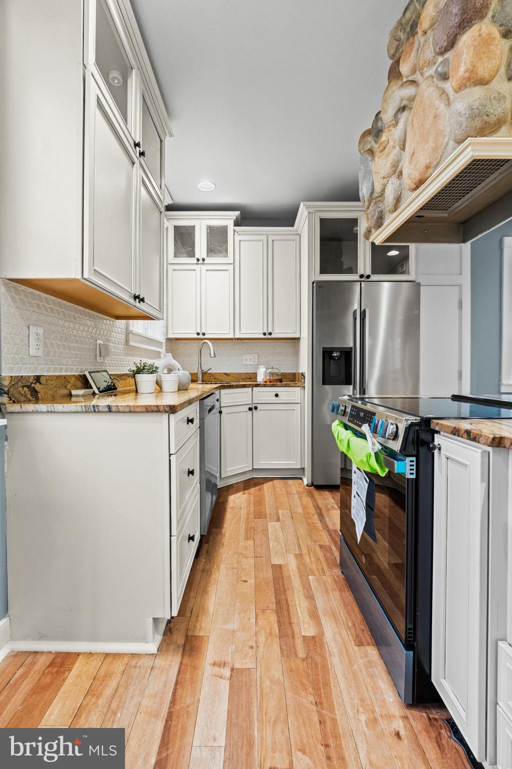 4604 Moravia Road Baltimore, MD 21206 - Photo 13 of 50 a kitchen with stainless steel appliances granite countertop a refrigerator and a stove top oven