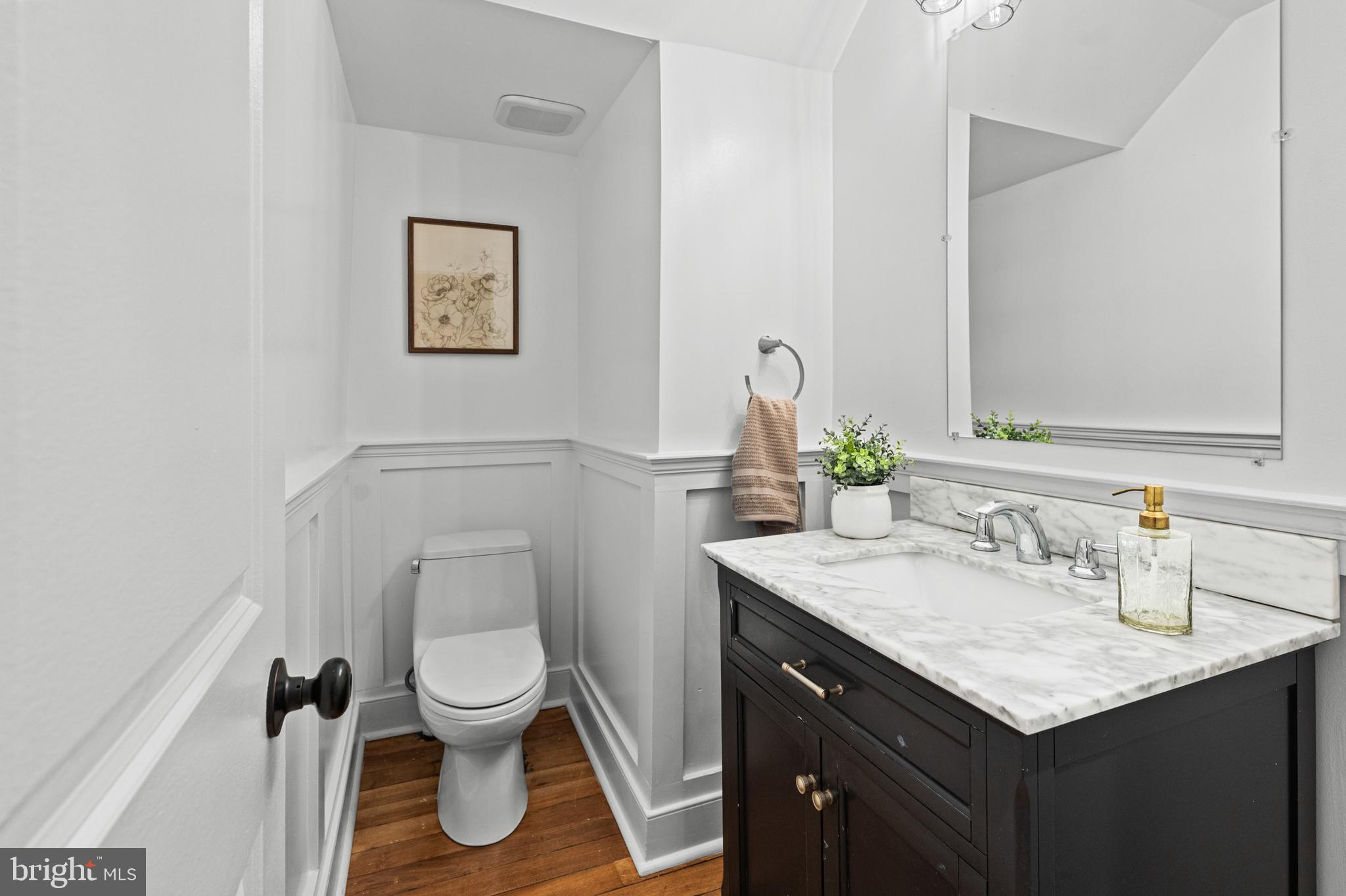 4604 Moravia Road Baltimore, MD 21206 - Photo 15 of 50 a bathroom with a granite countertop toilet sink and mirror