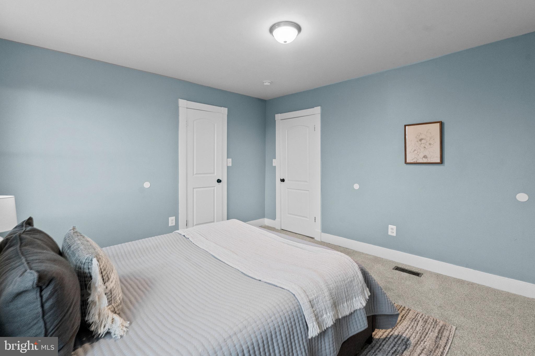 4604 Moravia Road Baltimore, MD 21206 - Photo 16 of 50 a bedroom with a bed and painting on the wall