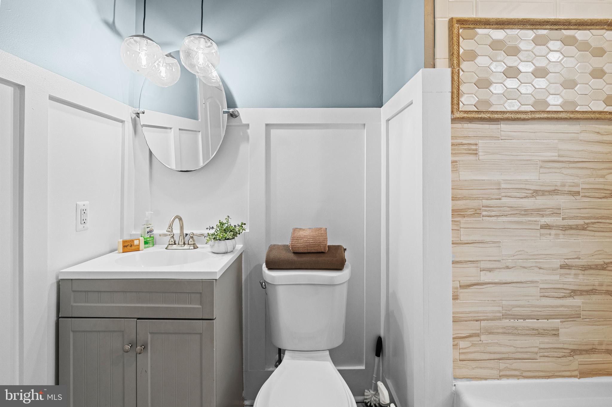 4604 Moravia Road Baltimore, MD 21206 - Photo 23 of 50 a bathroom with a sink a toilet and a mirror