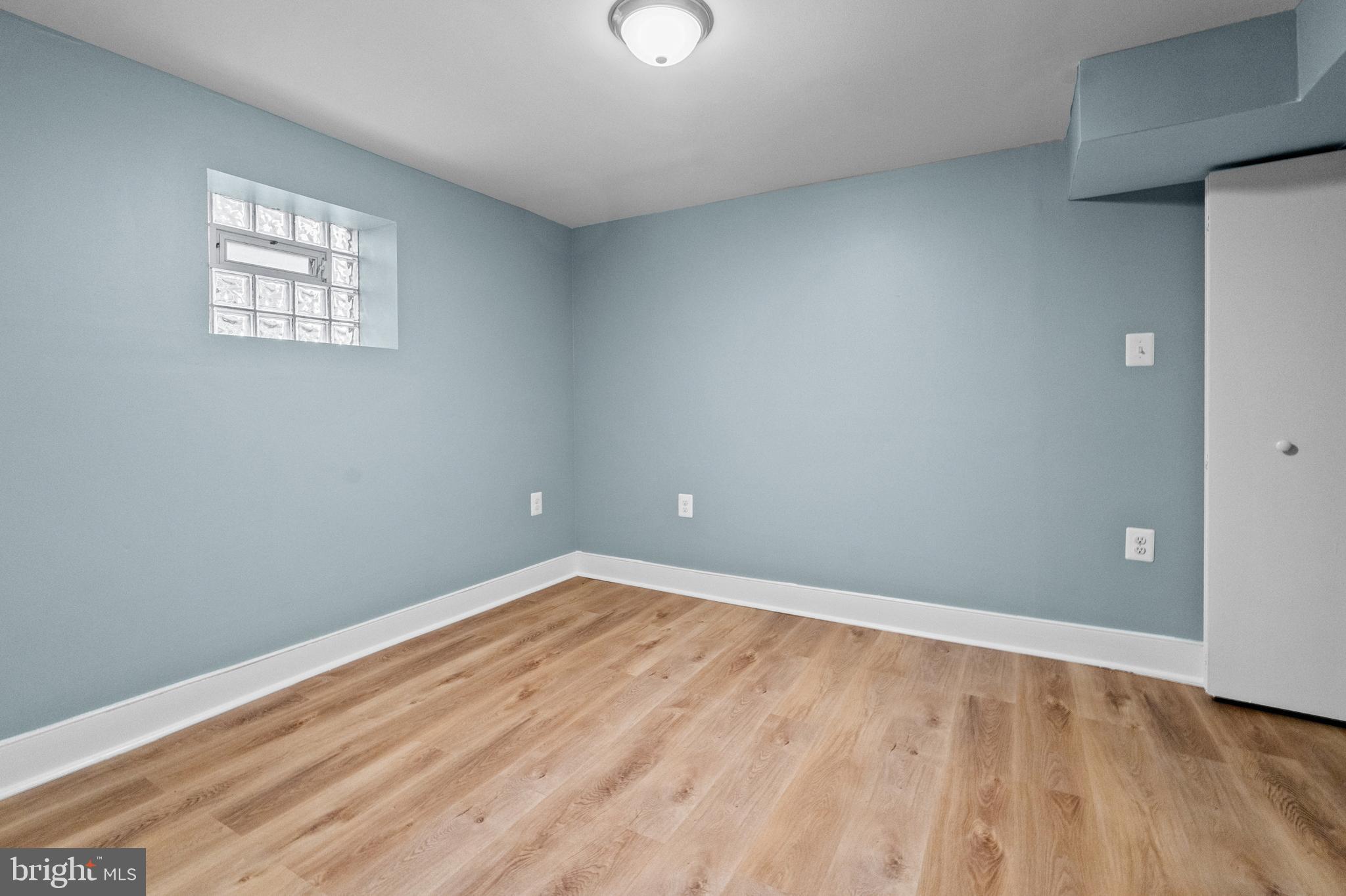 4604 Moravia Road Baltimore, MD 21206 - Photo 28 of 50 a view of an empty room with wooden floor and a window