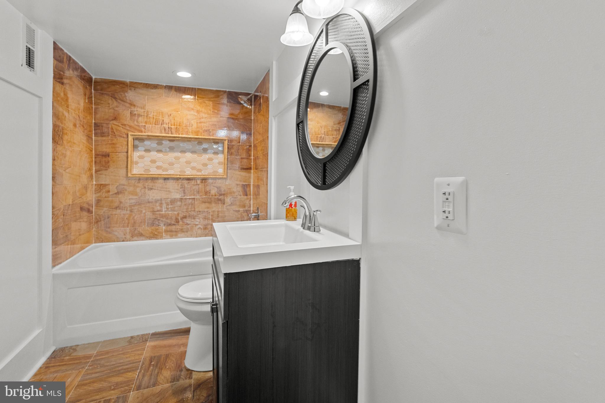 4604 Moravia Road Baltimore, MD 21206 - Photo 32 of 50 a bathroom with a sink a toilet and a mirror
