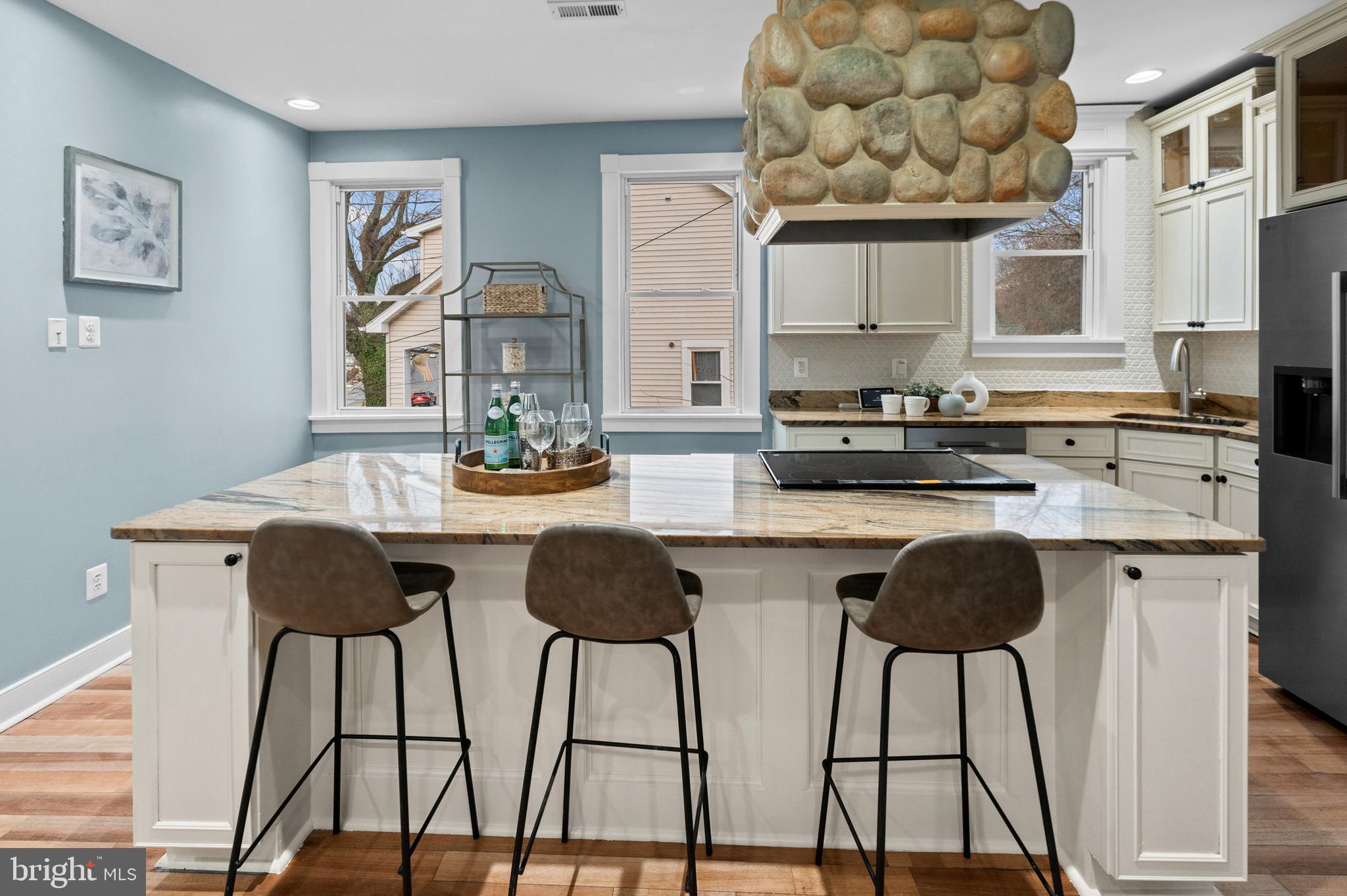 4604 Moravia Road Baltimore, MD 21206 - Photo 4 of 50 a kitchen with stainless steel appliances granite countertop a stove a sink and white cabinets with wooden floor