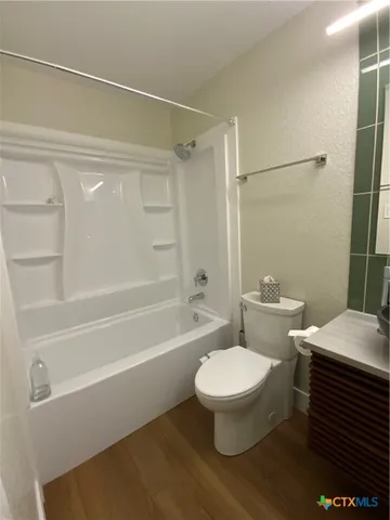 a bathroom with a toilet a sink and a shower