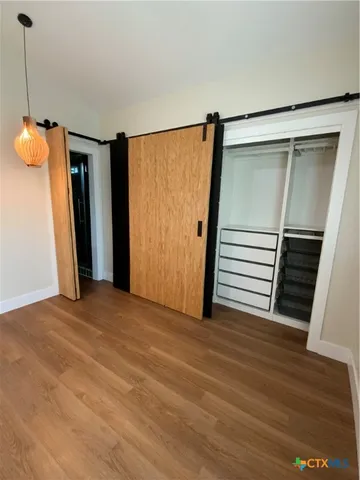 a view of a room with wooden floor and stairs