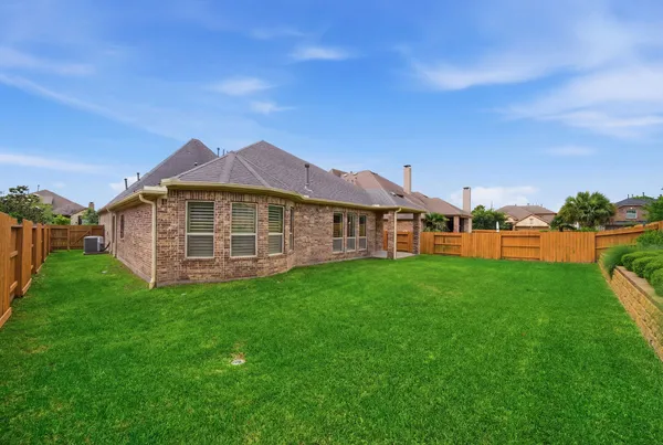 an aerial view of a house with a garden and trees