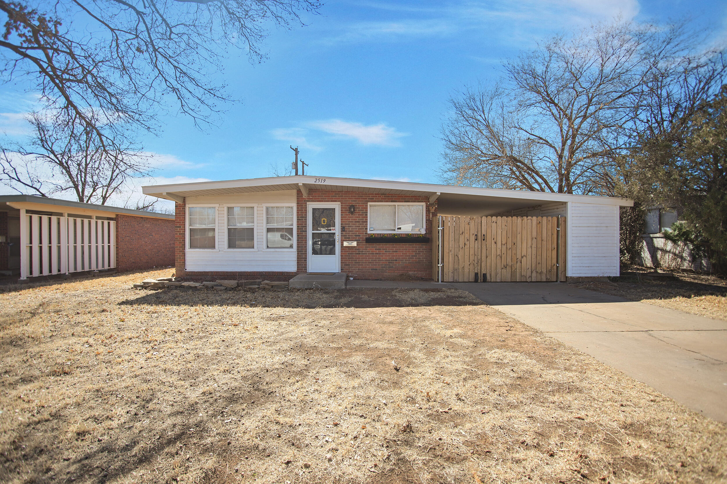 2519 62nd Street Lubbock, TX 79413 - Photo 1 of 30 a front view of a house with a garden