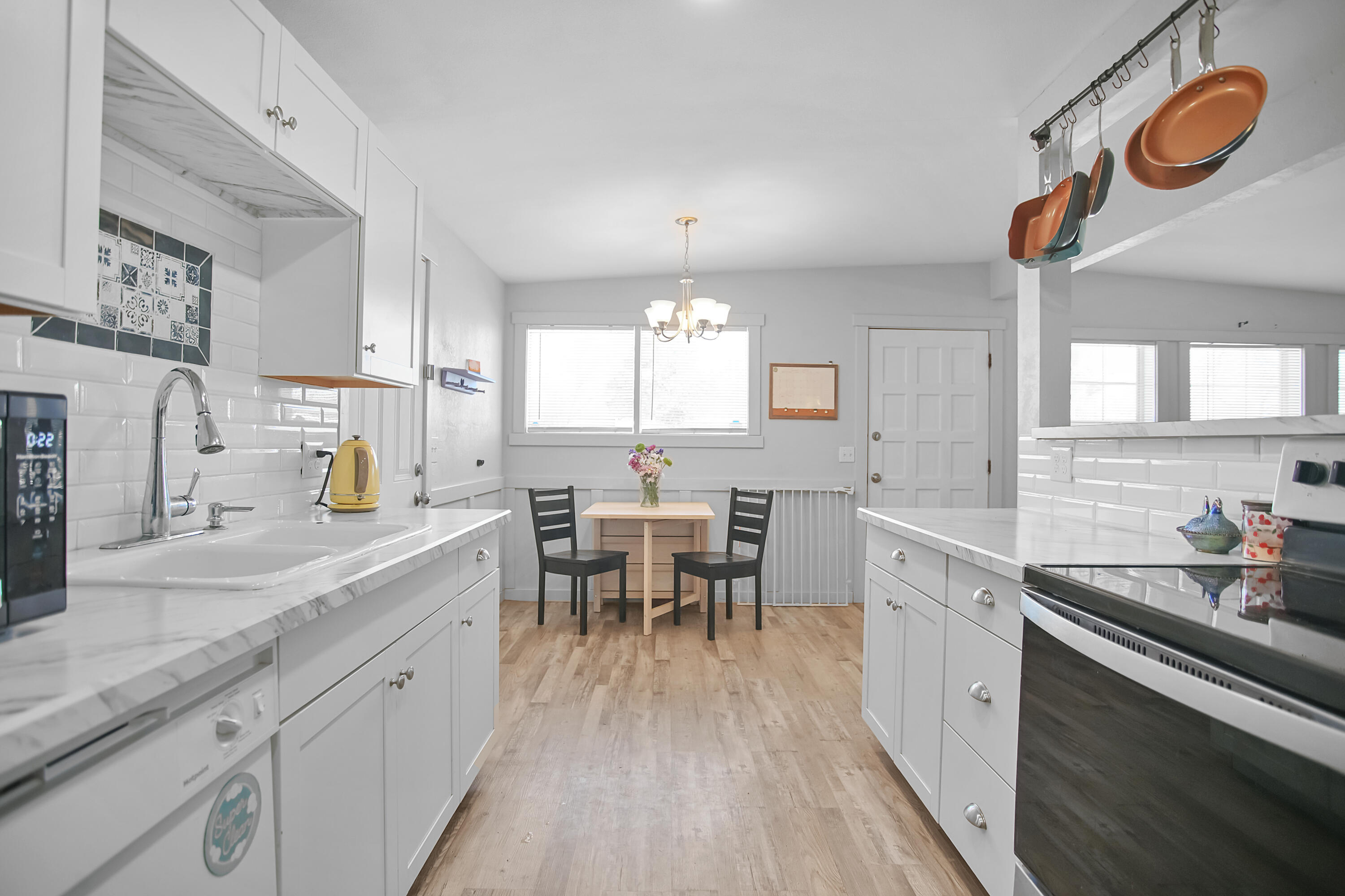 2519 62nd Street Lubbock, TX 79413 - Photo 11 of 30 a kitchen with cabinets and wooden floor