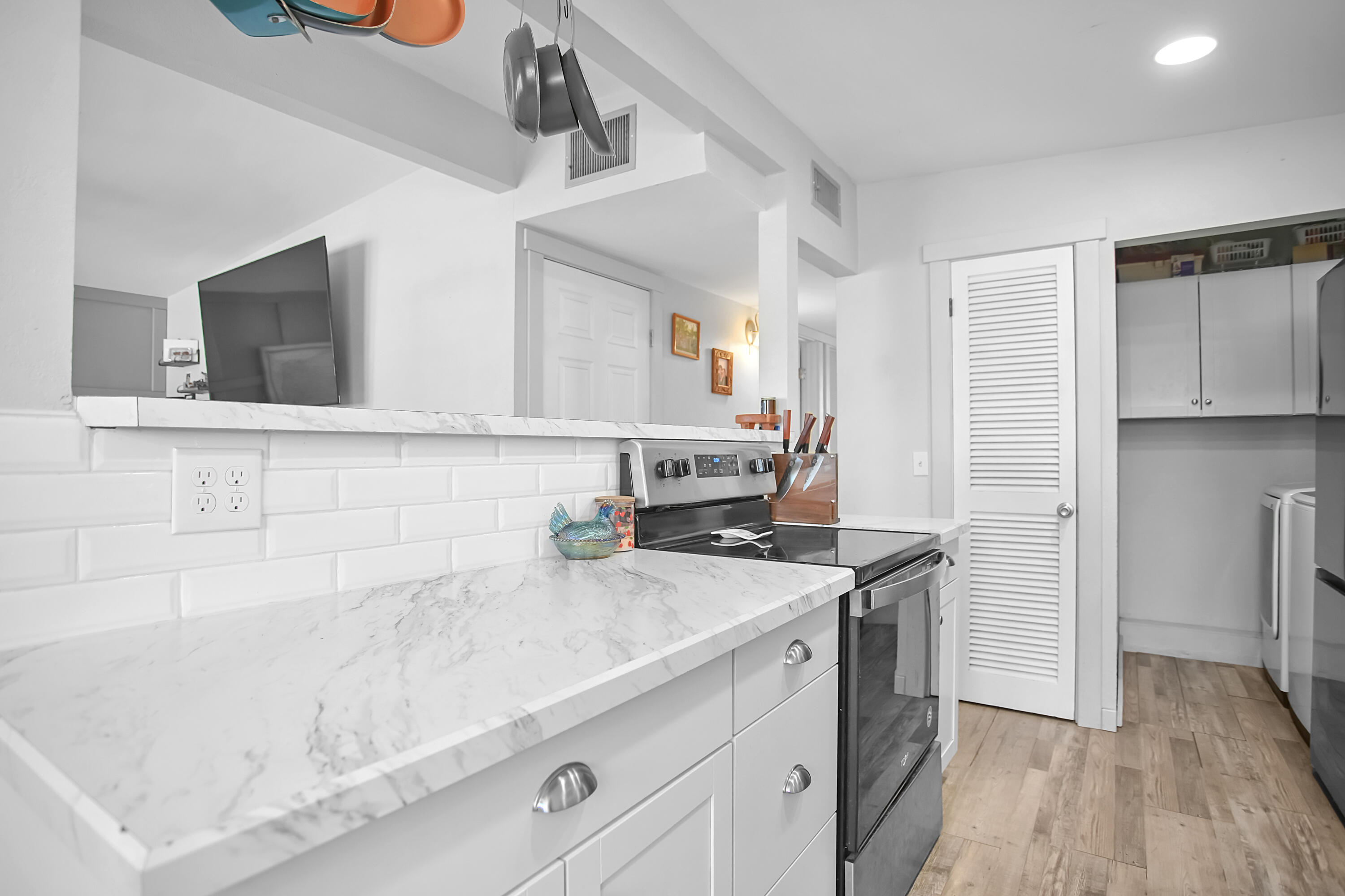 2519 62nd Street Lubbock, TX 79413 - Photo 13 of 30 a kitchen with a sink a microwave a refrigerator and cabinets