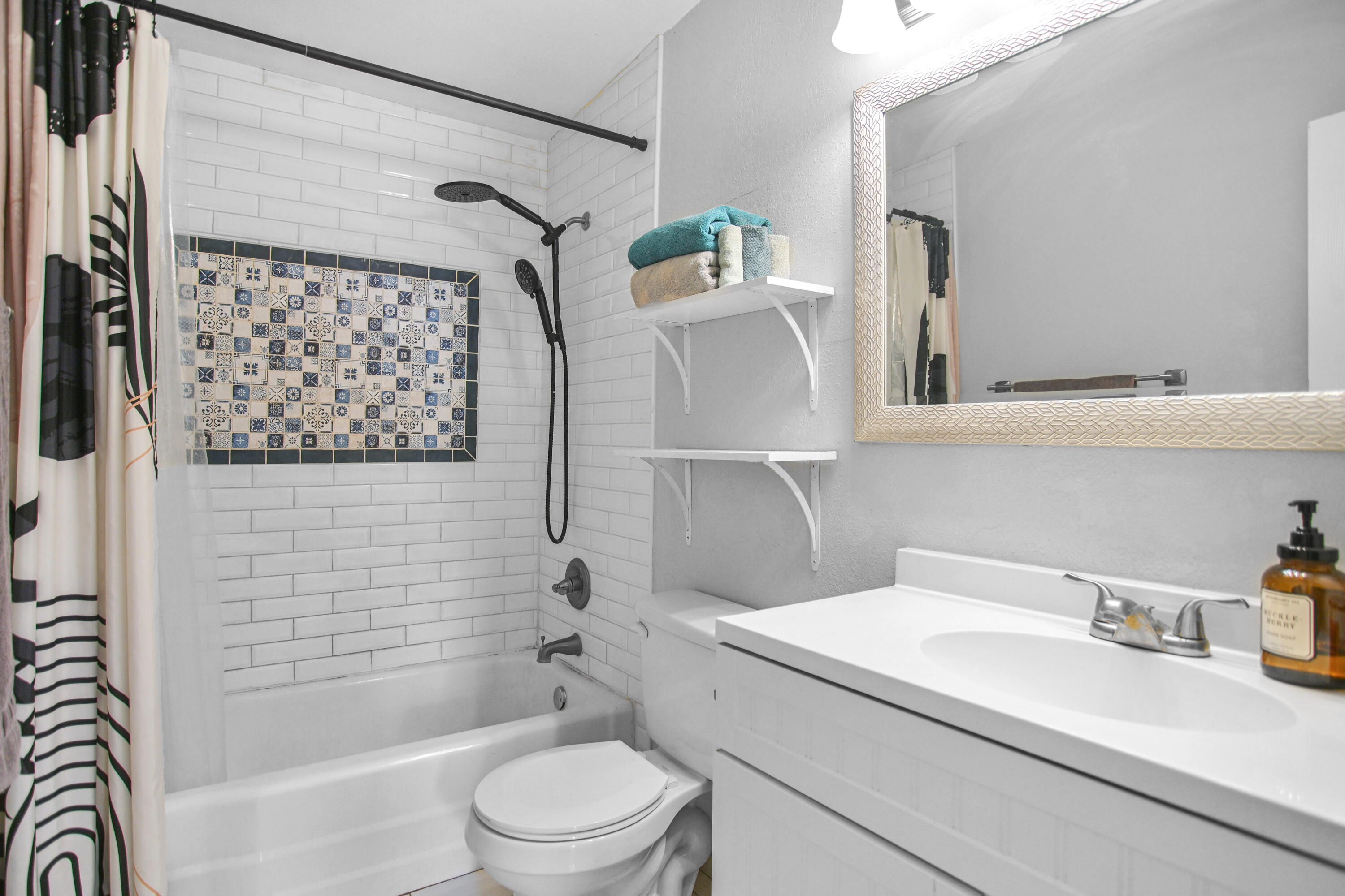 2519 62nd Street Lubbock, TX 79413 - Photo 17 of 30 a bathroom with a sink a toilet and shower