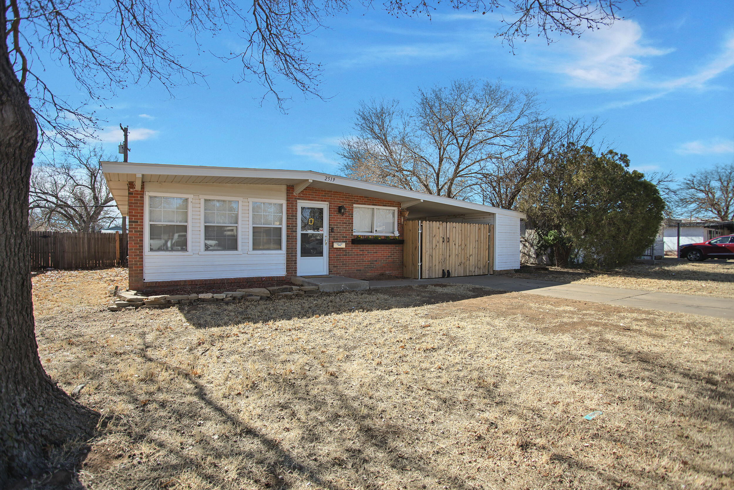 2519 62nd Street Lubbock, TX 79413 - Photo 2 of 30 a view of a house with a yard covered in snow