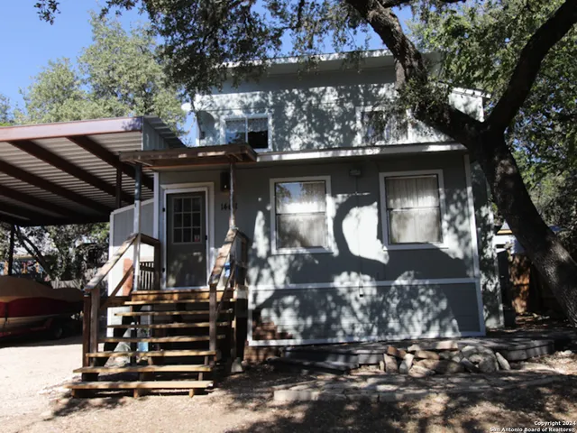 a view of a house with a large tree
