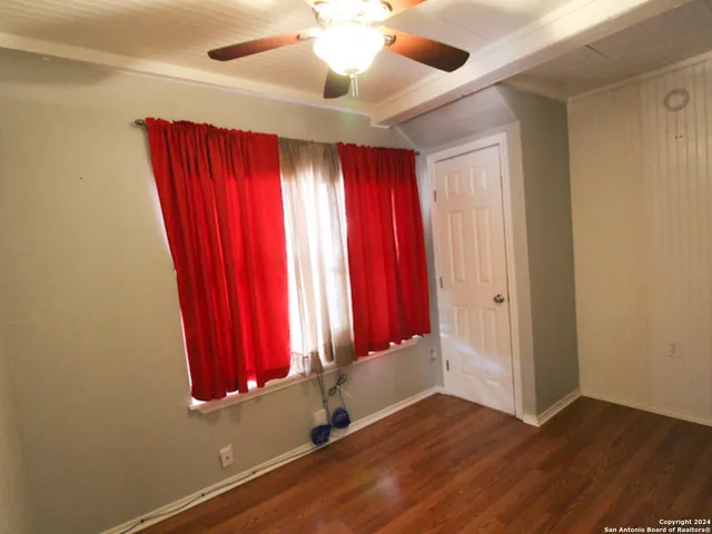 a view of a room with wooden floor and windows