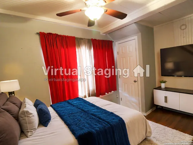 a bedroom with a bed and a flat screen tv