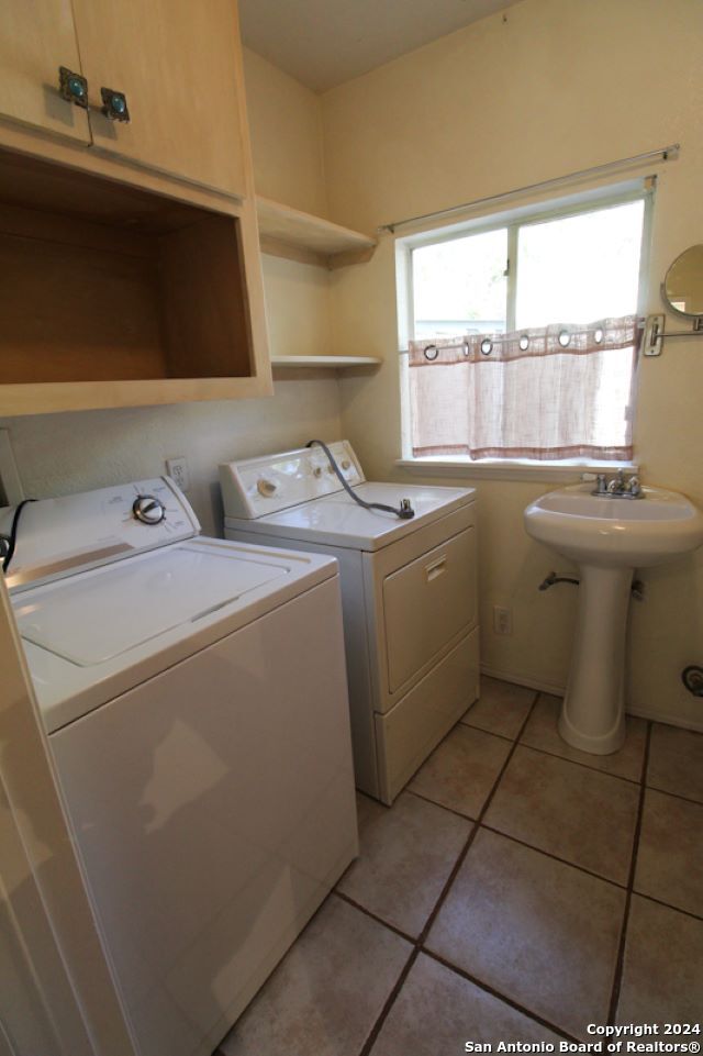1468 Pebble Beach Road Lakehills, TX 78063 - Photo 14 of 23 a utility room with dryer and washer