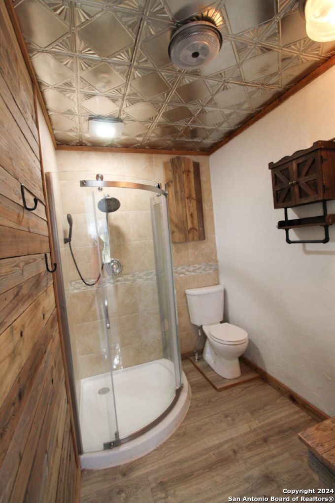 1468 Pebble Beach Road Lakehills, TX 78063 - Photo 18 of 23 a bathroom with a toilet and a shower