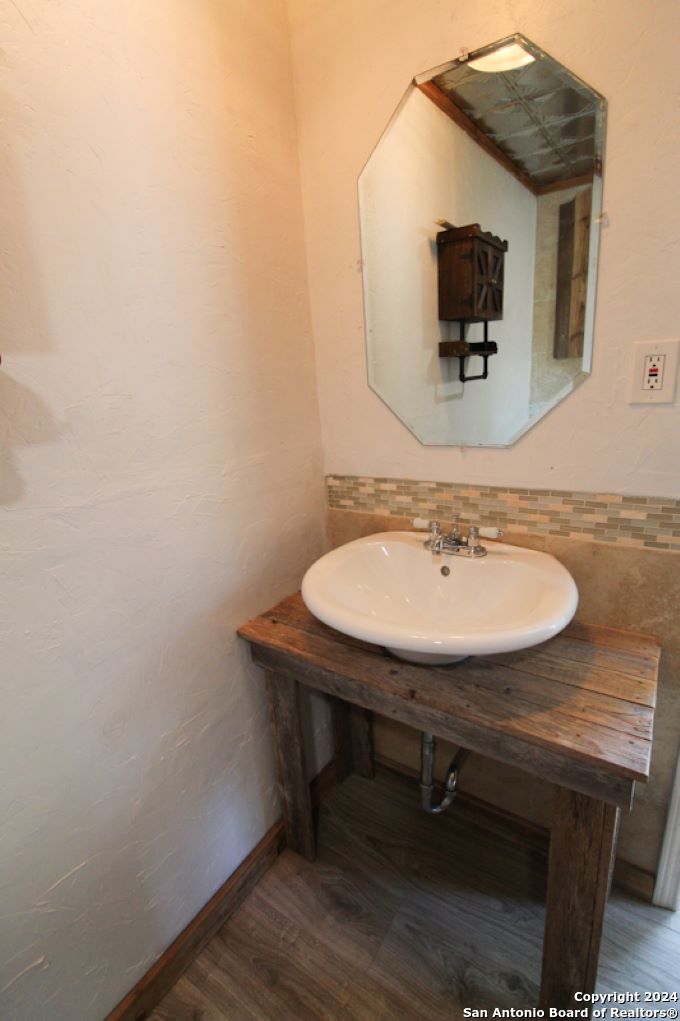 1468 Pebble Beach Road Lakehills, TX 78063 - Photo 19 of 23 a sink and a mirror