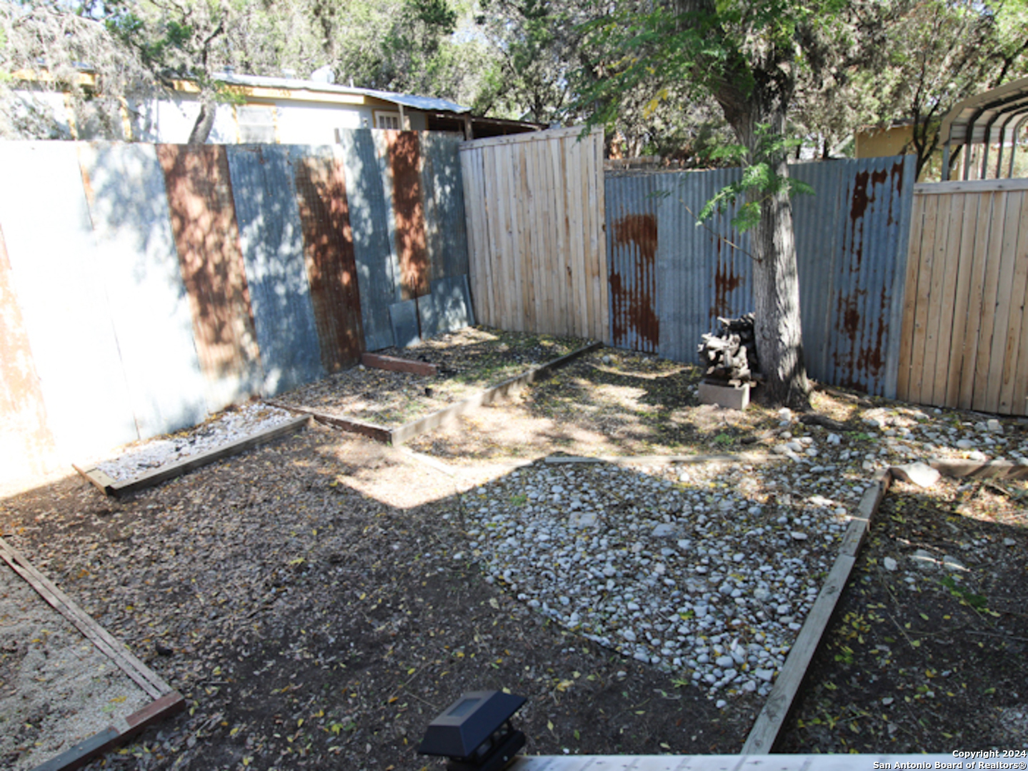 1468 Pebble Beach Road Lakehills, TX 78063 - Photo 22 of 23 a view of a backyard of the house