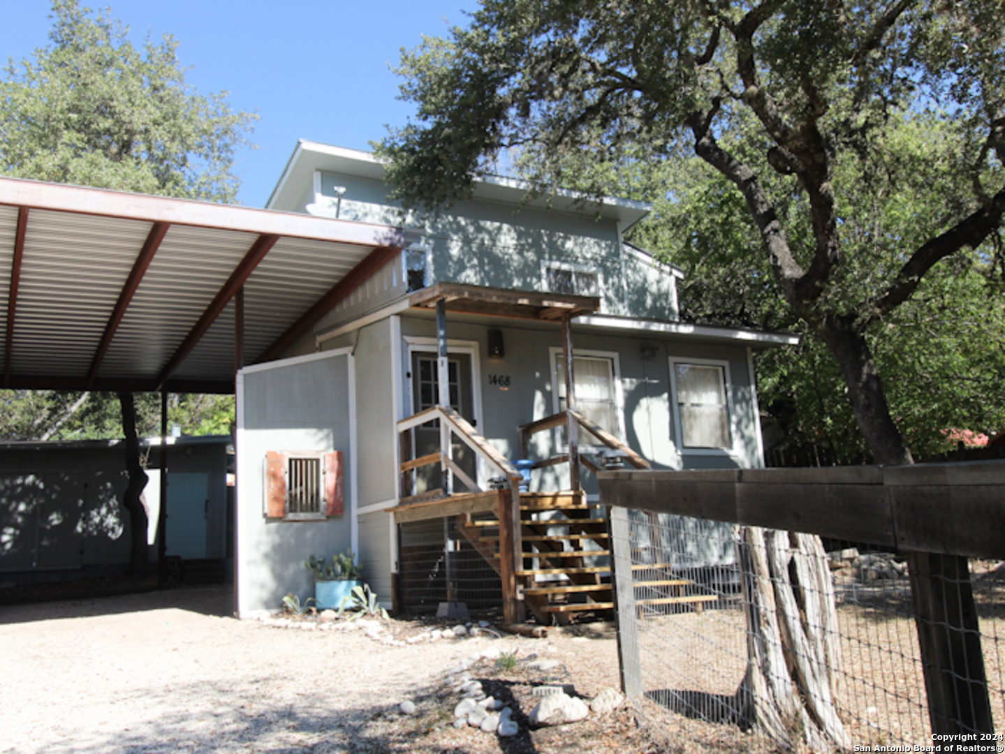 1468 Pebble Beach Road Lakehills, TX 78063 - Photo 4 of 23 a view of a house with a yard
