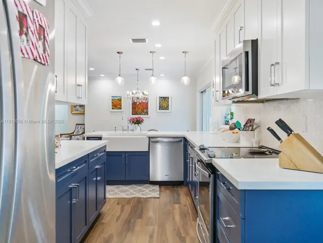 a kitchen with granite countertop a sink stove and cabinets