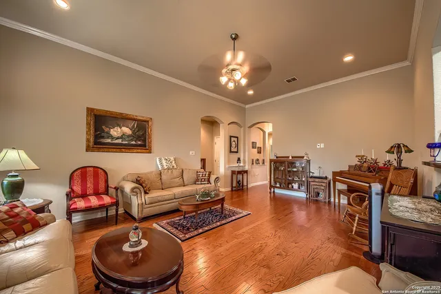 a living room with furniture a rug and a chandelier