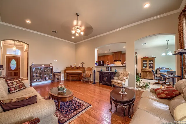 a living room with furniture and a chandelier