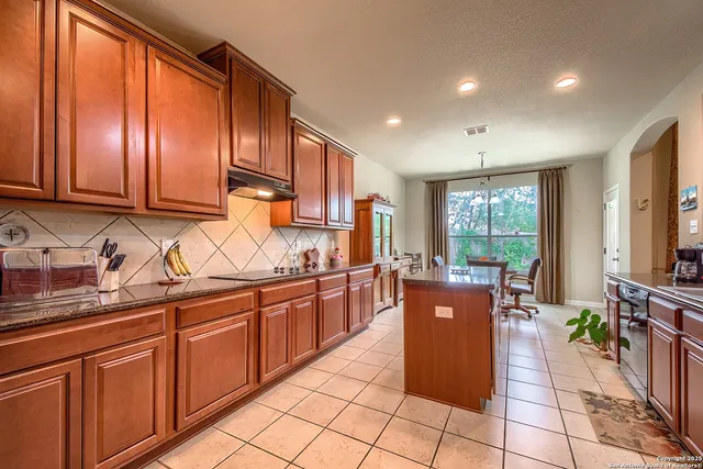 a kitchen with stainless steel appliances granite countertop sink stove and refrigerator
