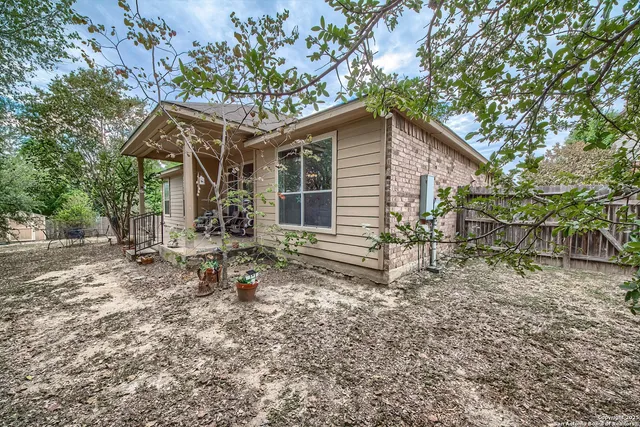 a backyard of a house with table and chairs