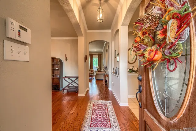 a view of a hallway with furniture and wooden floor
