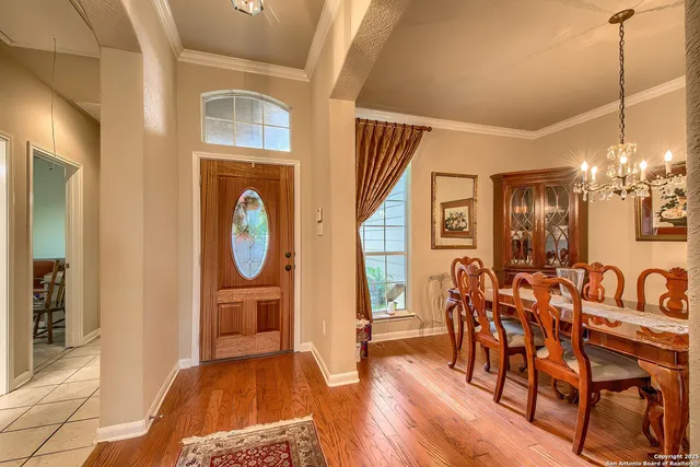 a view of a a dining room with furniture window and wooden floor