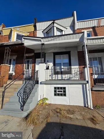 a view of a white building with large windows