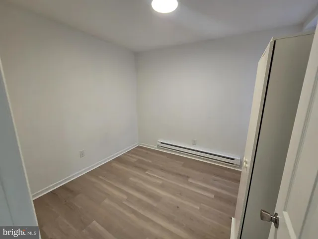 a room with a window and a wooden floor