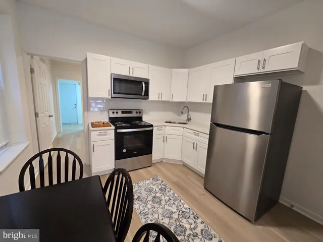 a kitchen with a refrigerator stove and microwave