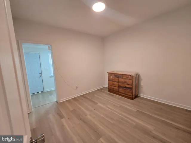 a view of an empty room and wooden floor