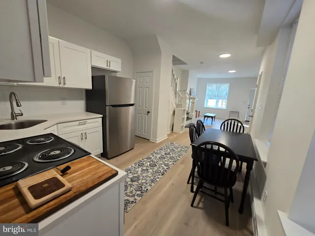 a kitchen with a stove and a refrigerator
