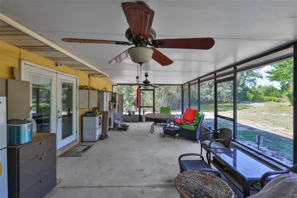 14451 Highland Road Wimauma, FL 33598 - Photo 9 of 80 a living room with furniture ceiling fan and a large window