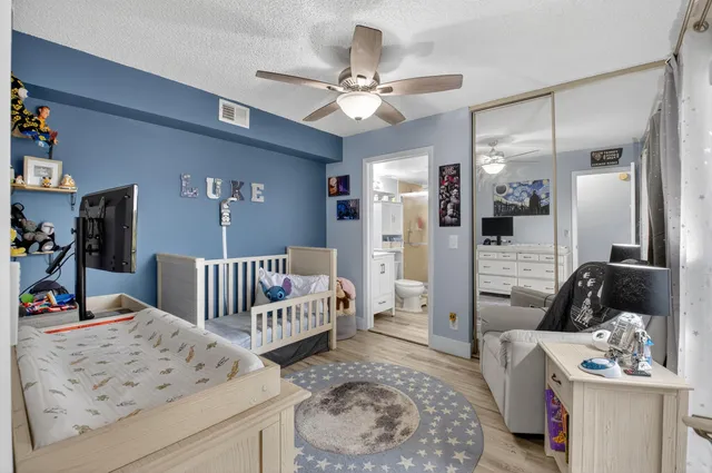 a bathroom with a sink a toilet a mirror a vanity and shower