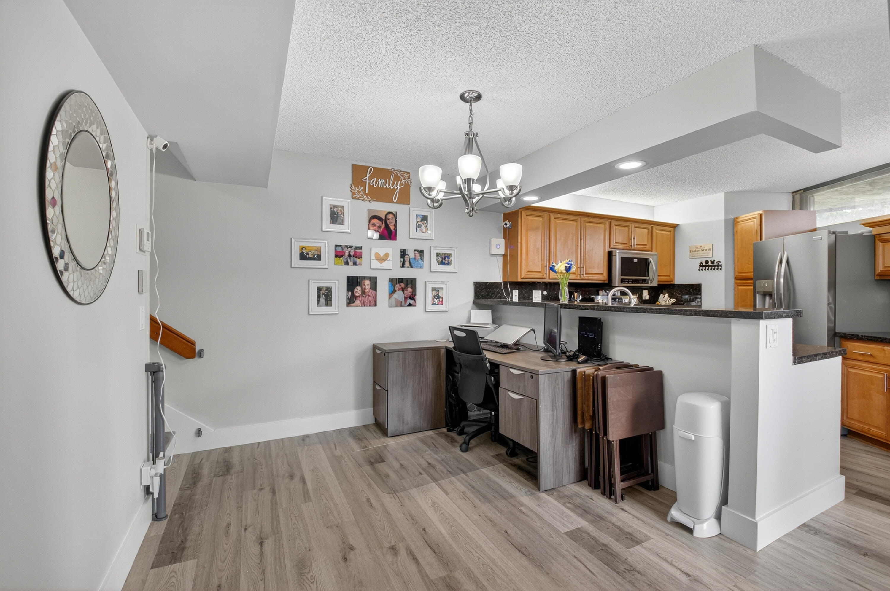 8200 Thames Boulevard, Unit C Boca Raton, FL 33433 - Photo 19 of 45 a kitchen with stainless steel appliances granite countertop a refrigerator a stove top oven a sink dishwasher and white cabinets with wooden floor
