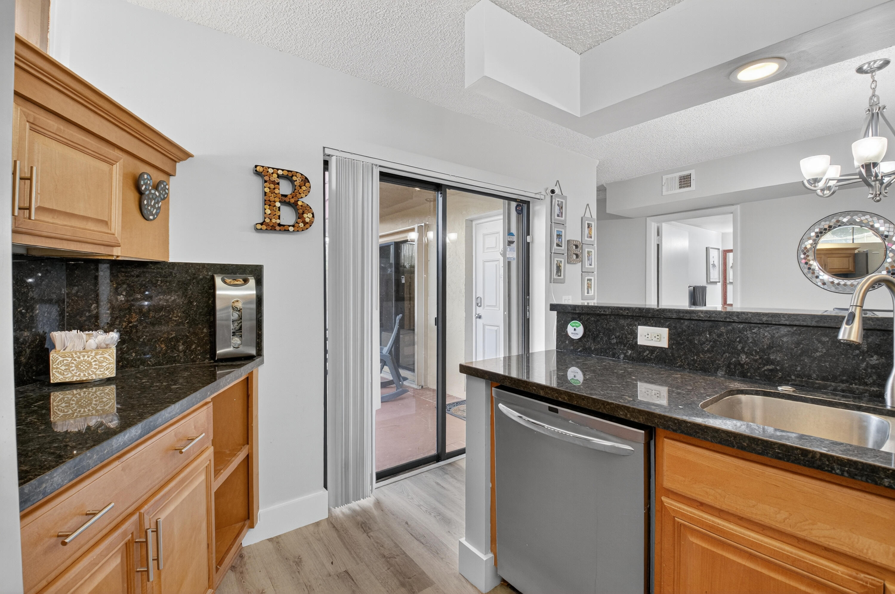 8200 Thames Boulevard, Unit C Boca Raton, FL 33433 - Photo 22 of 45 a large kitchen with granite countertop a sink and stainless steel appliances