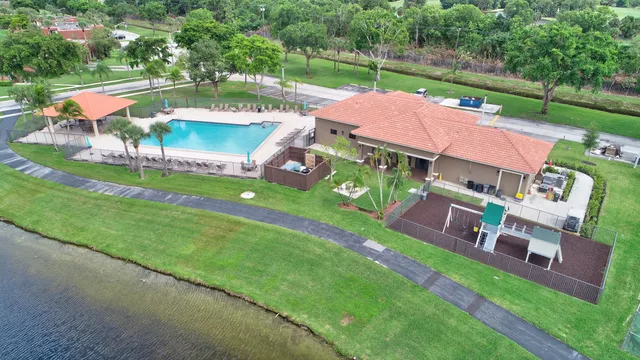 an aerial view of house with yard swimming pool and outdoor seating