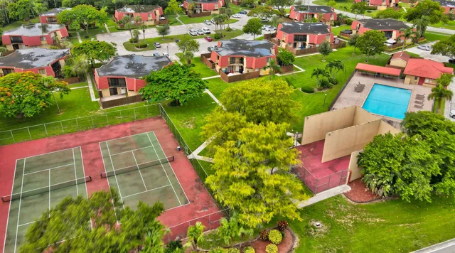 an aerial view of residential houses with yard