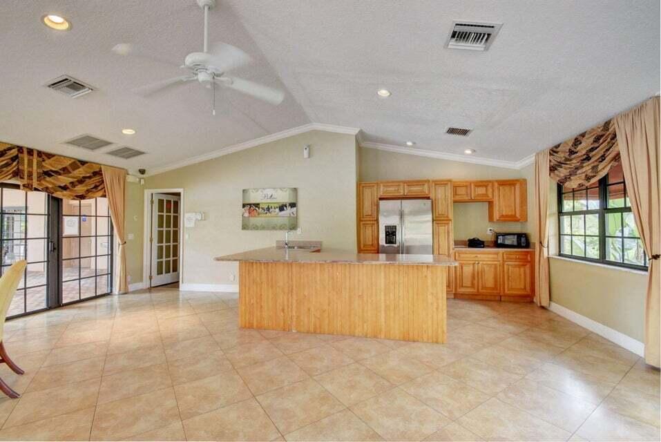 8200 Thames Boulevard, Unit C Boca Raton, FL 33433 - Photo 36 of 45 a large living room with a large window and a couch