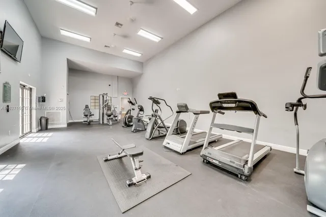 a room with gym equipment and a flat screen tv