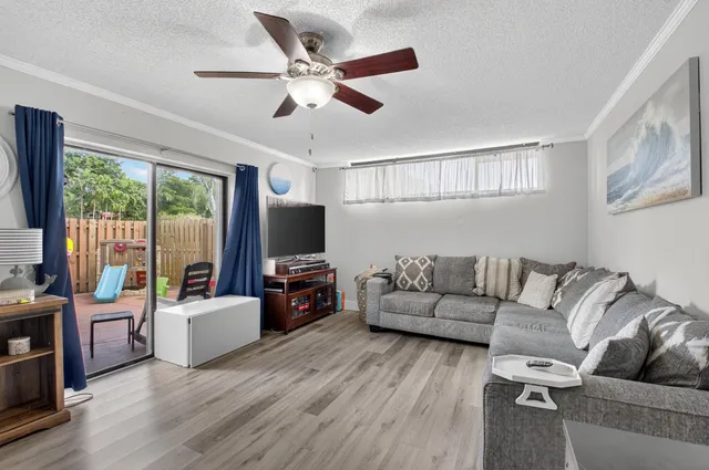 a bedroom with a bed and a flat tv screen on dresser