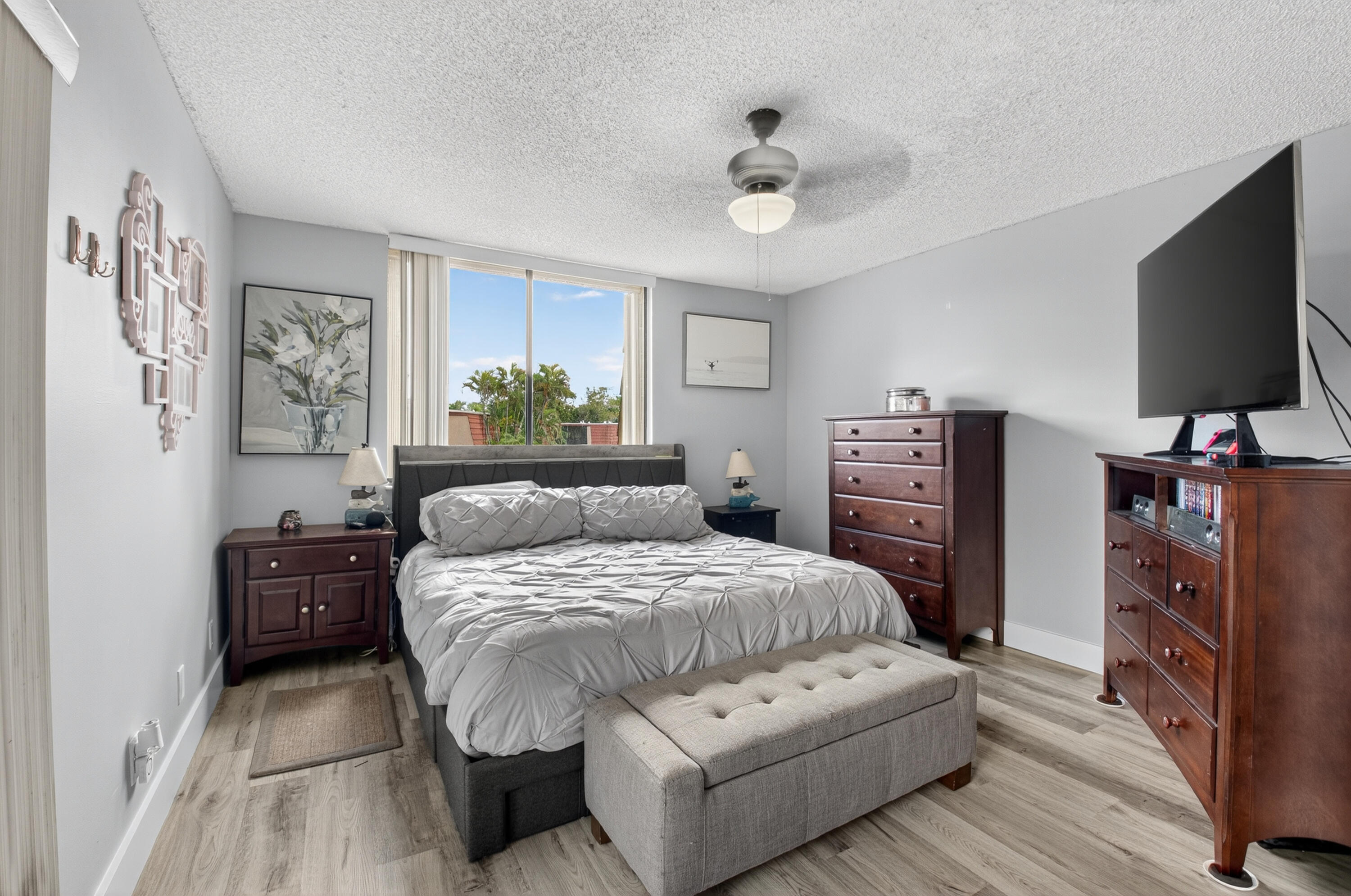 8200 Thames Boulevard, Unit C Boca Raton, FL 33433 - Photo 10 of 45 a bedroom with a bed and a flat tv screen on dresser