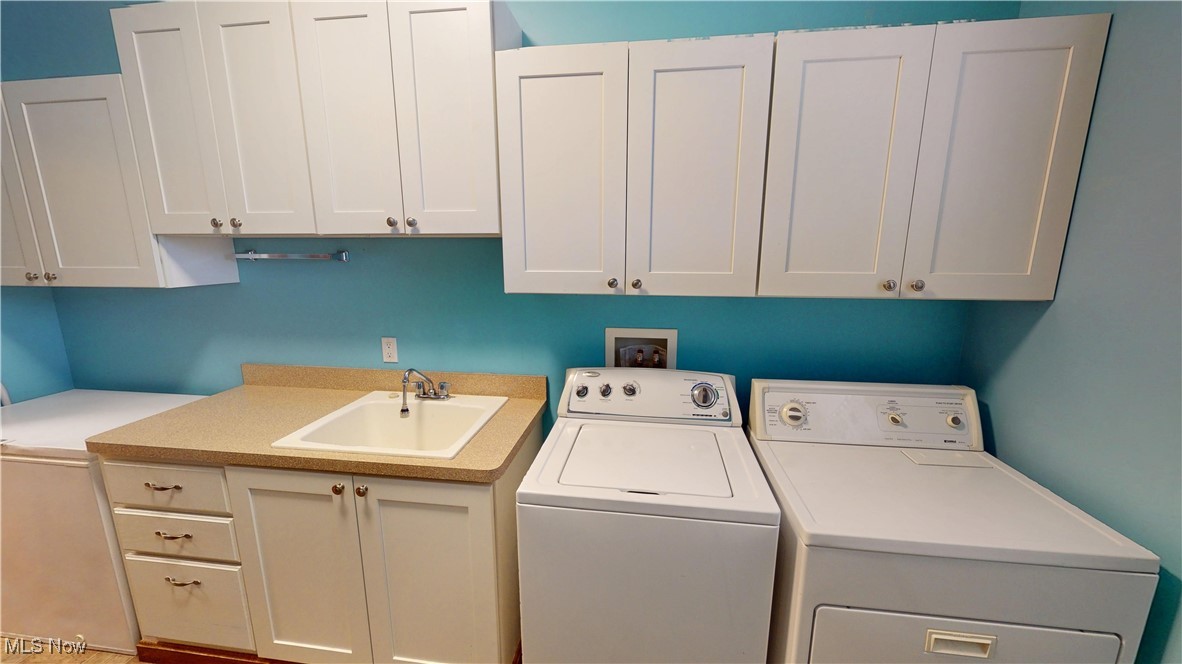 10323 Smith Road Litchfield, OH 44253 - Photo 18 of 50 Laundry room with a sink, cabinet space, and separate washer and dryer