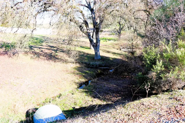 a backyard of a house with a yard and outdoor seating